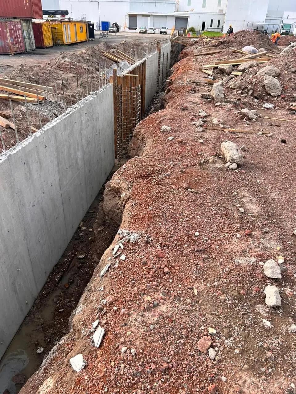 Poured retaining wall in a trench