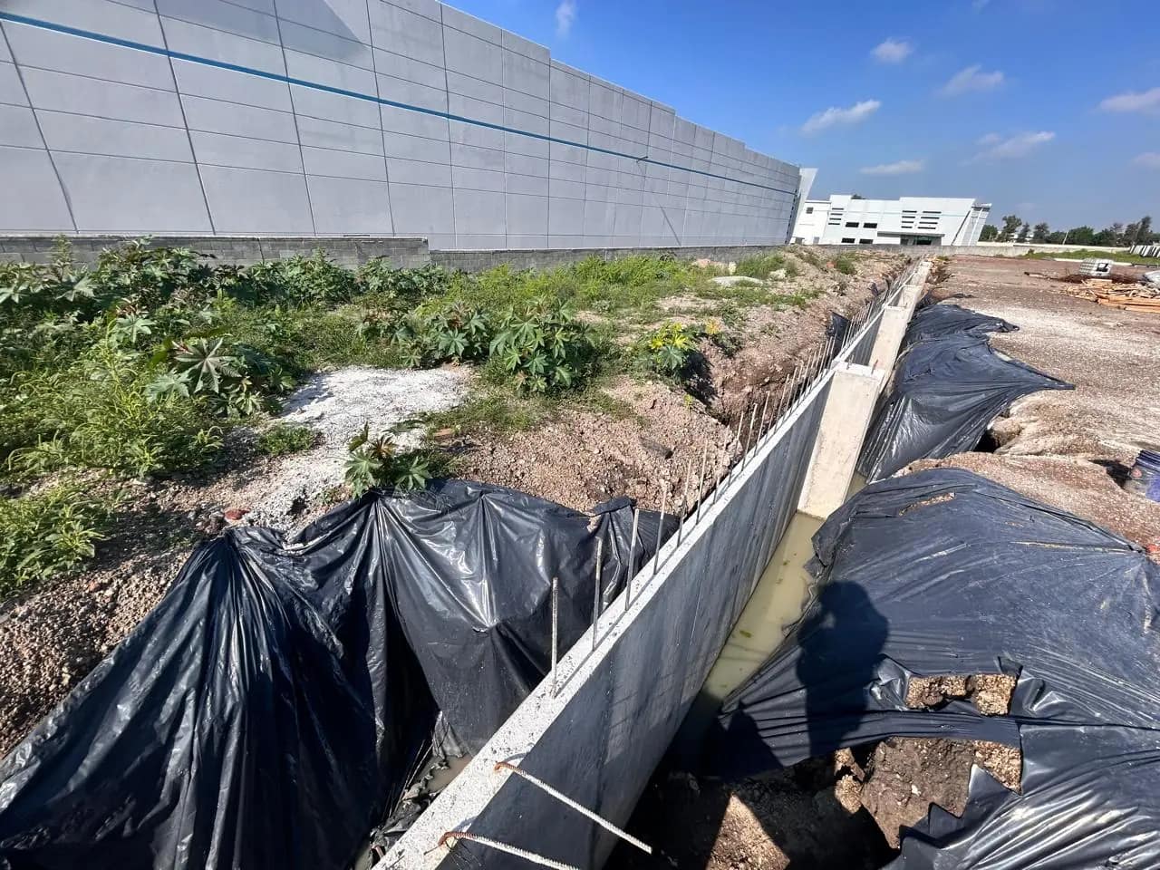 Lined trench for foundations next to a warehouse